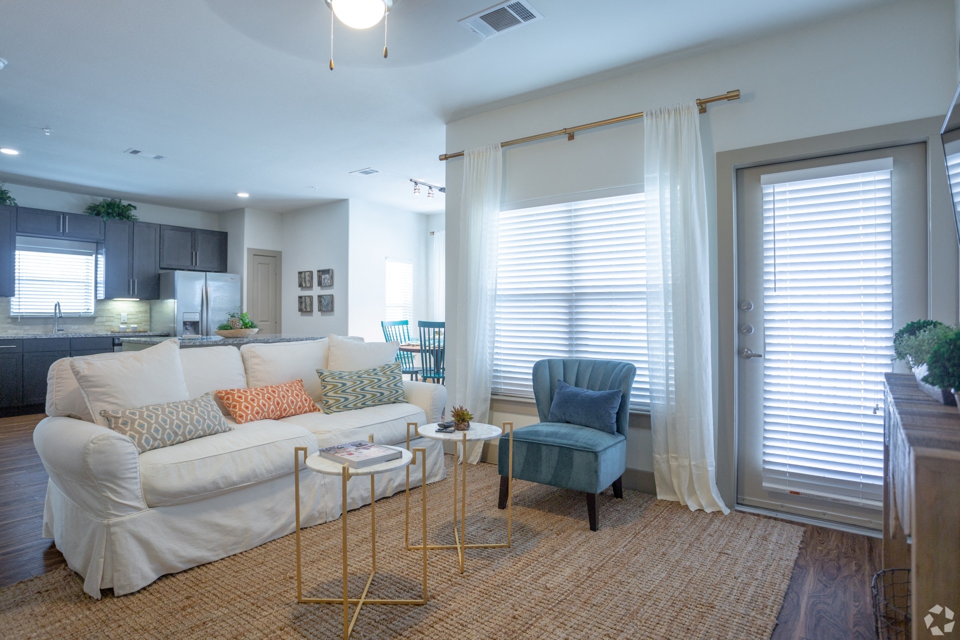 a living room with a white couch and a blue chair